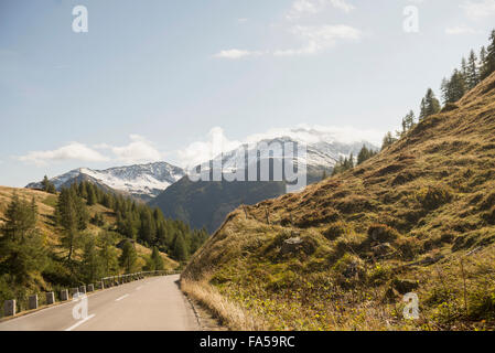 Road passing through mountains against cloudy sky, Grossglockner, Austrian Alps, Carinthia, Austria Stock Photo