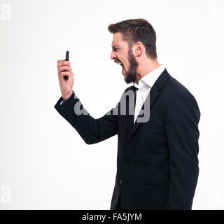 Portrait of a young angry businessman screaming on smartphone isolated on a white background Stock Photo