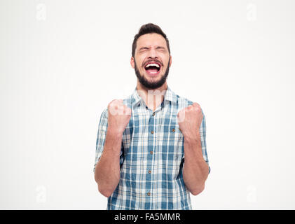Excited elated happy bearded young male in checkered shirt celebrating success over white background Stock Photo