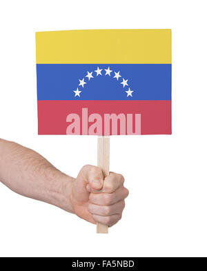 Hand holding small card, isolated on white - Flag of Venezuela Stock Photo