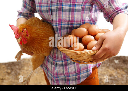 The farmer took the chicken and the egg Stock Photo