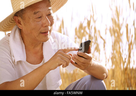 Farmers use mobile phones Stock Photo