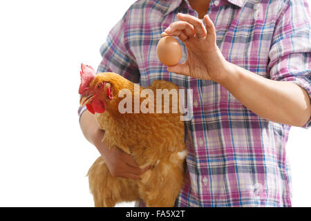 The farmer took the chicken and the egg Stock Photo