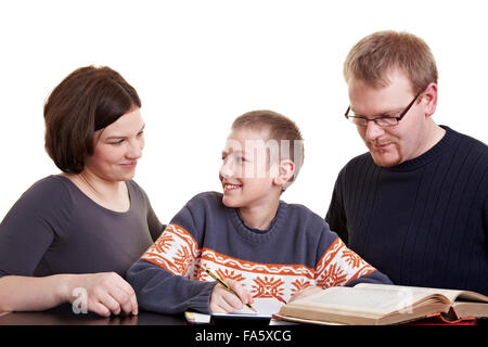 Father and mother helping son who is doing his homework Stock Photo
