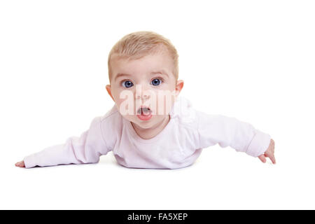 Amazed baby laying on floor with open mouth Stock Photo