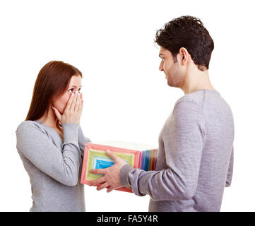 Man giving his surprised girlfriend a a gift Stock Photo