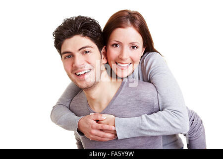 Smiling man giving young woman a piggyback ride Stock Photo
