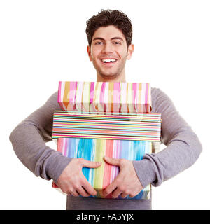 Young smiling happy man carrying christmas gifts Stock Photo