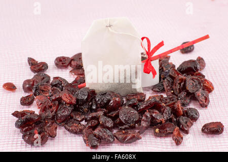 Colorful dried cranberry fruit grains and cranberry tea bag Stock Photo