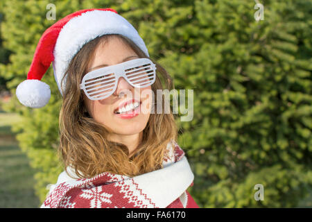 Portrait of a beautiful Santa Claus girl with party sunglasses Stock Photo