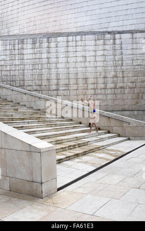 Man in swimming costume doing handstand outside Guggenheim Museum in Bilbao Spain Stock Photo