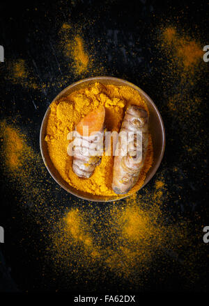 directly above shot of Turmeric roots and turmeric powder Stock Photo