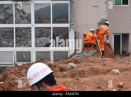 Beijing, China's Guangdong Province. 22nd Dec, 2015. Rescuers work at the site of landslide at an industrial park in Shenzhen, south China's Guangdong Province, Dec. 22, 2015. One body was dug out around 6 a.m. on Tuesday morning after dozens of people were buried in Sunday's landslide in Shenzhen. The number of missing people in the landslide was revised to 85 from 91, the local government said on Monday evening. Credit:  Jin Liangkuai/Xinhua/Alamy Live News Stock Photo