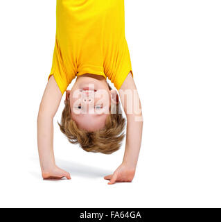 Handsome little boy hanging upside down Stock Photo