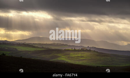 Sunlight streaming through clouds, Pienza, Tuscany, Italy Stock Photo