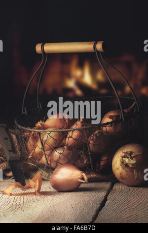 fresh onion and shallot on a wooden table in a warm kitchen Stock Photo