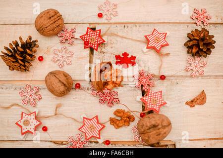 Pine cones, nuts and Christmas ornaments on a wooden table Stock Photo