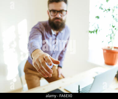 Beard business man with arm extended to handshake Stock Photo