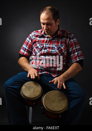 portrait of musician with bongo , studio shot Stock Photo