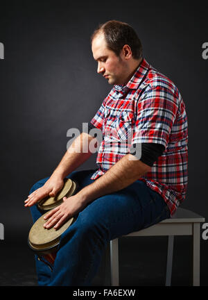 portrait of musician with bongo , studio shot Stock Photo