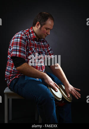 portrait of musician with bongo , studio shot Stock Photo