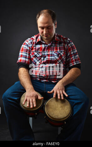 portrait of musician with bongo , studio shot Stock Photo