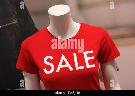 Sale printed on red T-shirt of a mannequin in a shop window. Stock Photo