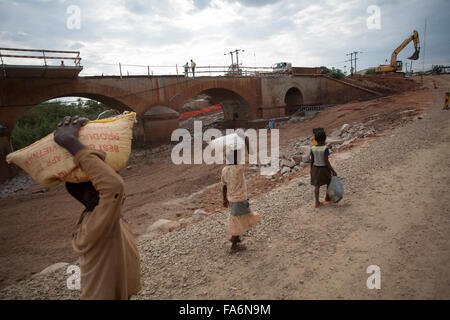 Construction workers rehabilitate an aging bridge along the Namialo to Rio Lurio Road in Northern Mozambique, SE Africa. Stock Photo