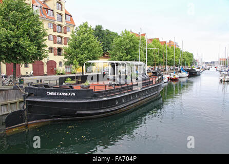COPENHAGEN - JULY 28, 2012: Touristic boat modified into restaurant on Christianshavns Kanal in Copenhagen, Denmark Stock Photo