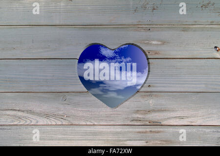 heart shaped hole in the old dried planks Stock Photo