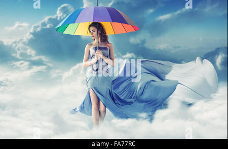 Brunette walking on the fluffy white clouds Stock Photo