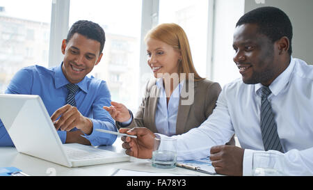 Group of business people discussing plans on computer Stock Photo