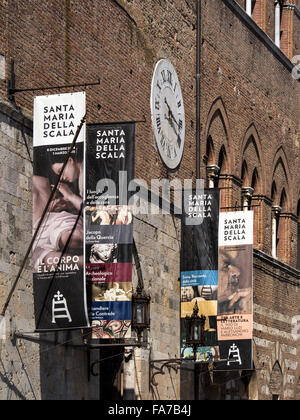 SIENA,  ITALY - AUGUST 05, 2015:  Banner signs outside the Santa Maria Della Scala Museum Stock Photo
