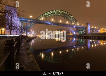 Night time photograph of the Tyne Bridge taken from Newcastle quayside looking across the Tyne towards Gateshead. Stock Photo