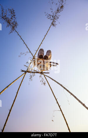 Young person playing on a traditional bamboo swing called linge ping in Nepal Stock Photo
