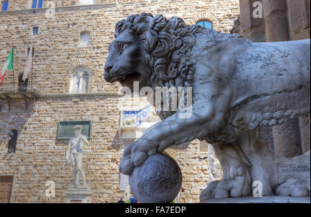 Italy,Tuscany, Florence, lion sculpture and Michelangelo's David in Piazza della Signoria Stock Photo