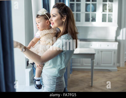 Mother and little baby relaxing in a stylish interior Stock Photo