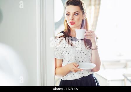 Premium Photo  Beautiful morning the girl is waiting for her coffee an  automatic drip coffee maker stands with a yellow cup on a white table  electric kitchen small household appliances