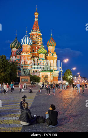 Tourists in the Red Square in front of Saint Basil's Cathedral illuminated at night. Moscow, Russia. Stock Photo