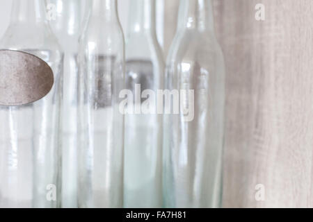 Empty old style bottles decorating kitchen in residential house, Cambridge. A house combining modern minimalist style with display of traditional objects used in every day life. Stock Photo