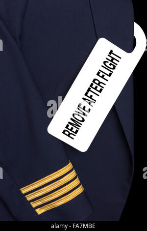 Pilot uniform with hotel room tag and caption Stock Photo