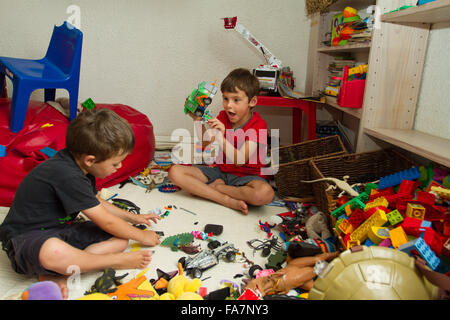 Two toddler brothers playing with toys Stock Photo