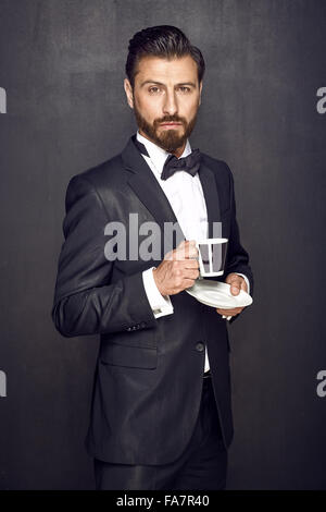 Elegant handsome guy drinking coffee Stock Photo