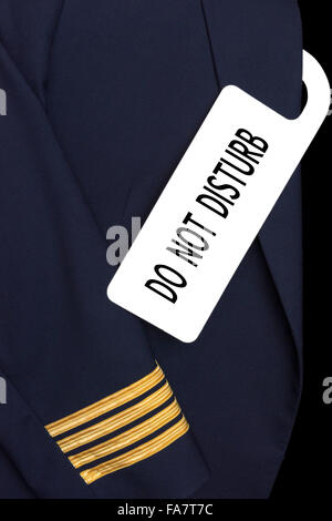 Pilot uniform with hotel room tag and caption Stock Photo