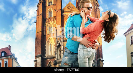 Portrait of a kissing young couple resting in  downtown Stock Photo