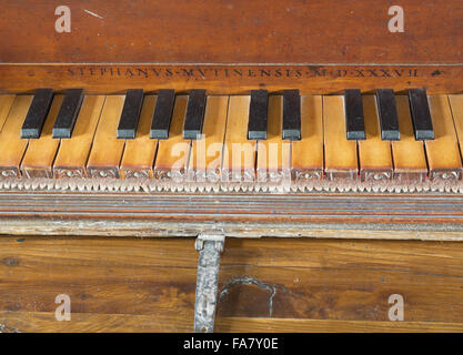 16th century virginals showing a detail of the inscription (and date of 1537) over the keyboard, in the Music Room at Westwood Manor, Wiltshire. Stock Photo