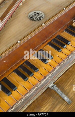 A 16th century virginals showing a detail of the inscription (and date of 1537) over the keyboard, in the Music Room at Westwood Manor, Wiltshire. Stock Photo