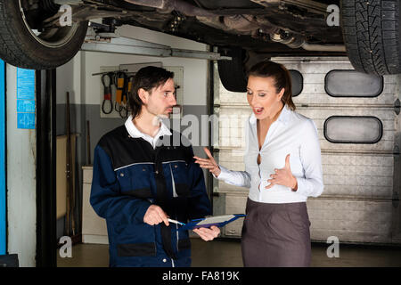 Car mechanic with angry female customer Stock Photo