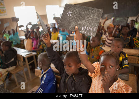 Students use small slate blackboards at Kouka Primary School in Kouka Department, Burkina Faso. Stock Photo