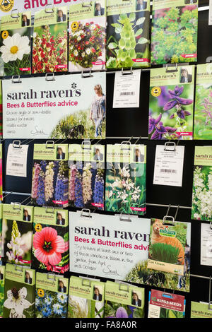 Packets of Johnsons Sarah Raven bee and butterfly friendly flower seeds for sale on a display stand in a garden centre Stock Photo